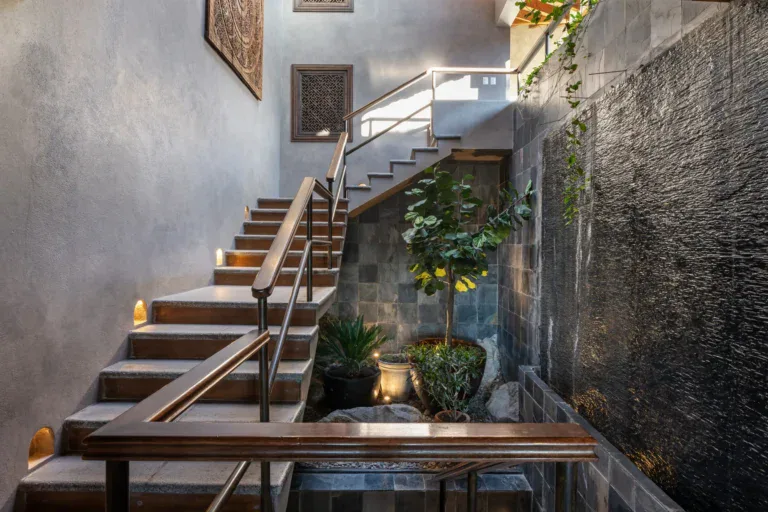 Casa Zen, wood staircase beside a slate water wall and a potted lemon tree, San Miguel de Allende