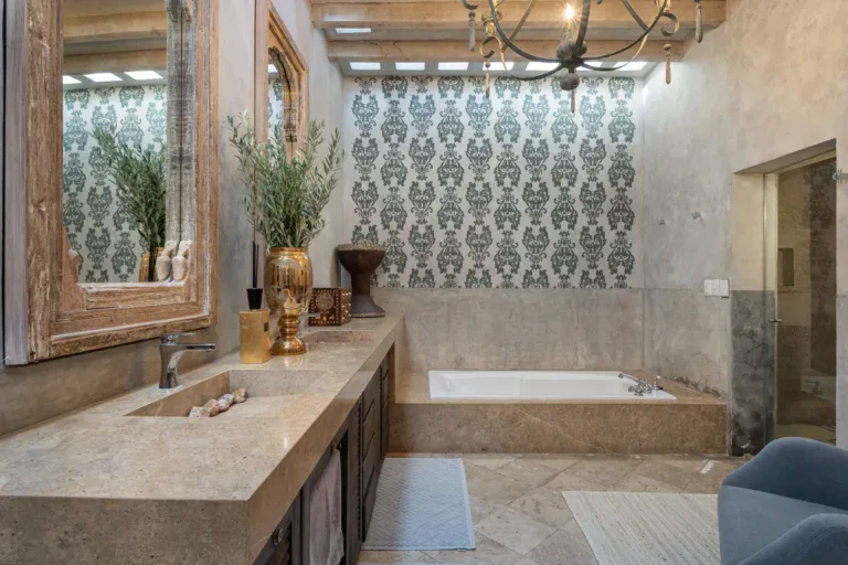 Casa Zen, bathroom with a double stone vanity, carved mirrors and a soaking tub, San Miguel de Allende
