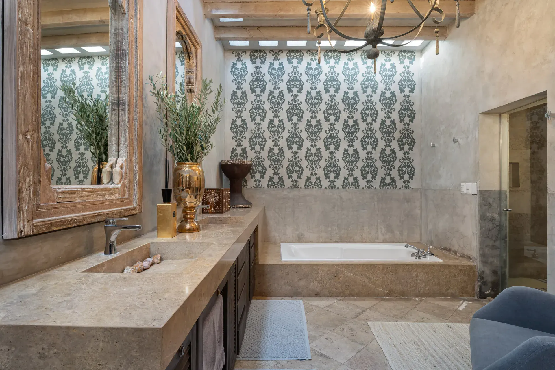 Casa Zen, bathroom with a double stone vanity, carved mirrors and a soaking tub, San Miguel de Allende