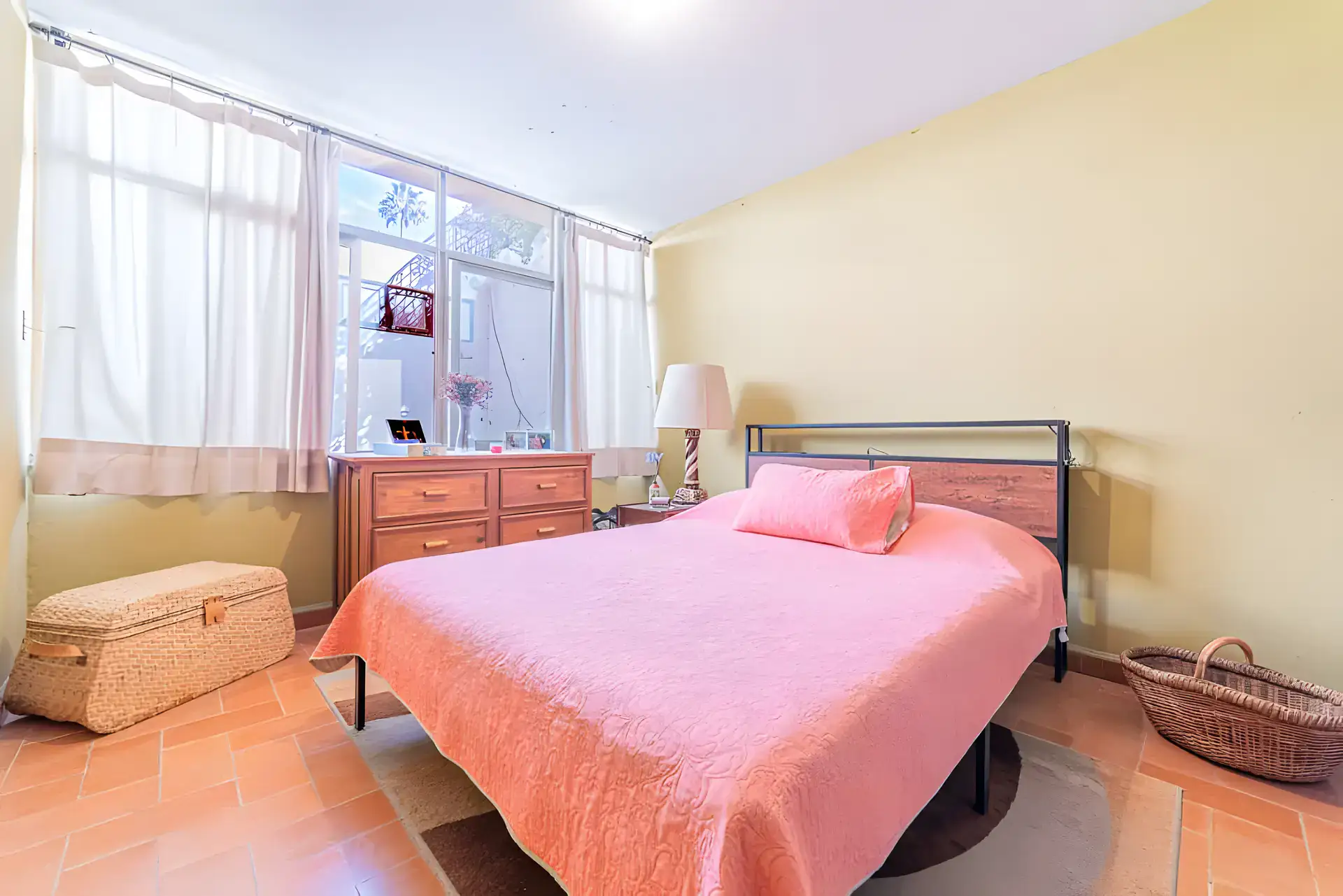 Casitas Terraplen, bedroom with a pink bedspread, a wood dresser and large garden windows, San Miguel de Allende