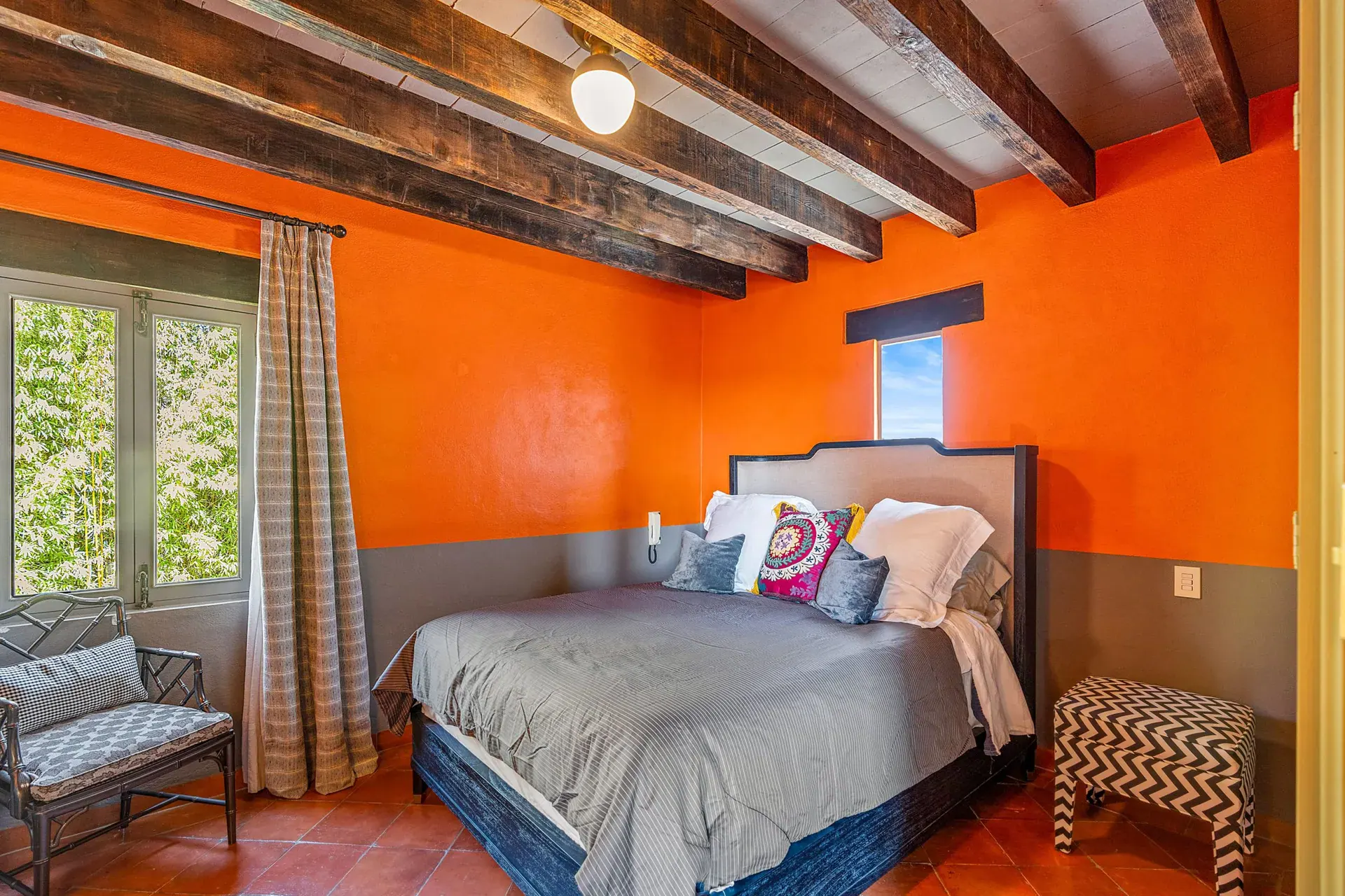 Cuesta de San Jose 22, bedroom with orange walls, a gray bedspread, a bench with a chevron pattern and a timber ceiling, San Miguel de Allende