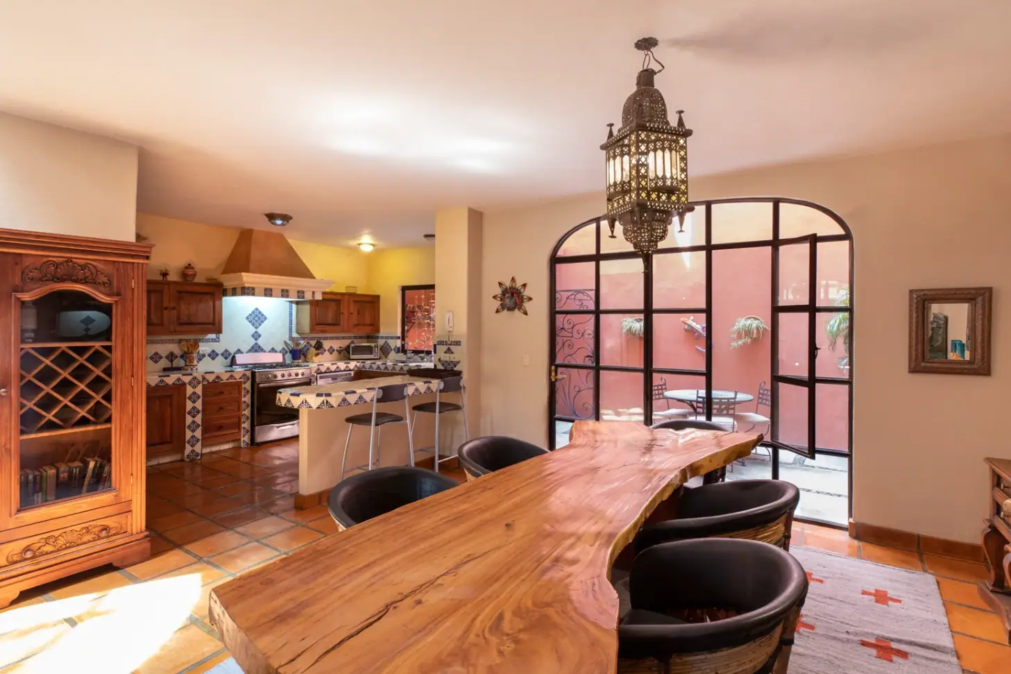 Casa Brillante, dining area with a live-edge wood table and open kitchen, San Miguel de Allende