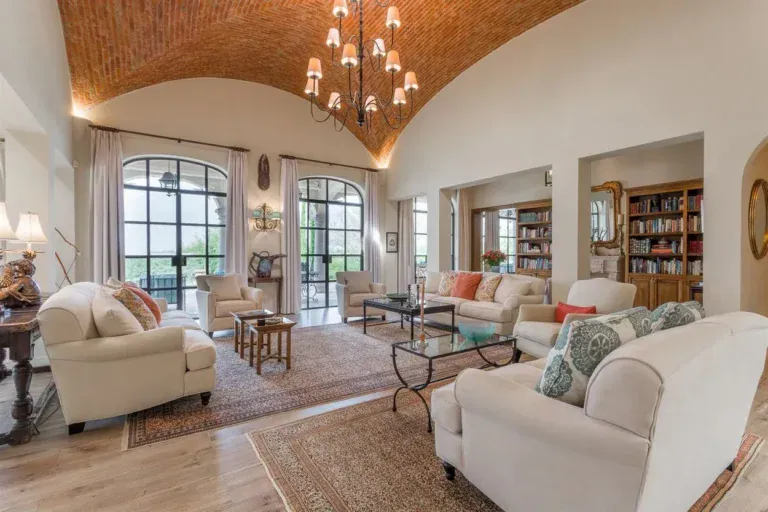 Finca Garambullos, living room with a vaulted brick ceiling, cream sofas and arched windows, San Miguel de Allende