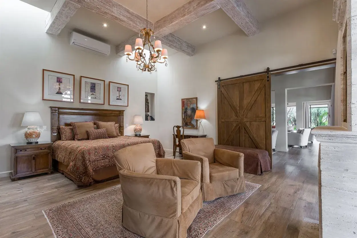 Finca Garambullos, primary bedroom with a sitting area and a barn door, San Miguel de Allende