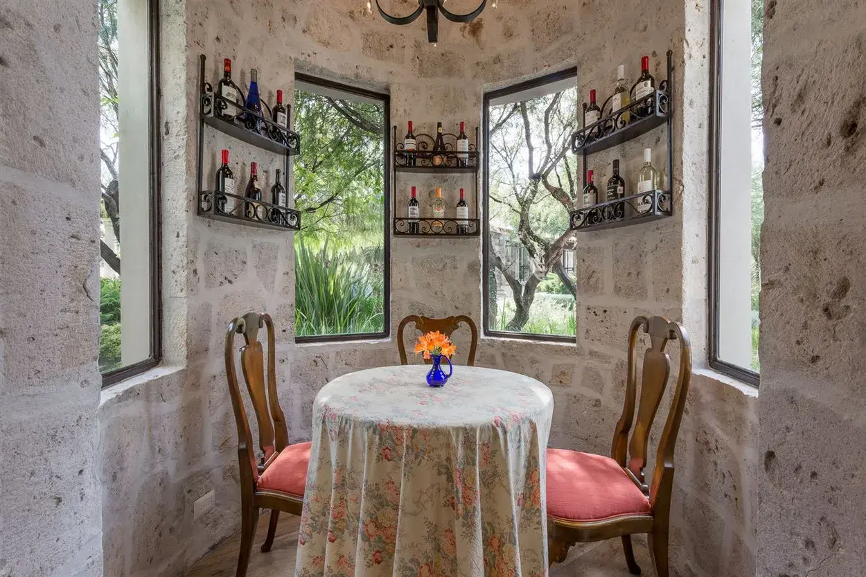Finca Garambullos, wine nook with a round table and a stone tower, San Miguel de Allende