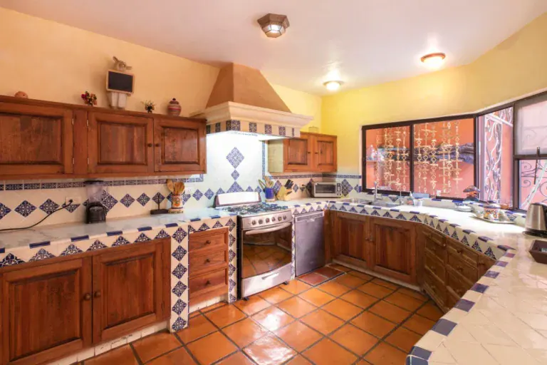 Casa Brillante, kitchen with wood cabinets and Talavera tile counters, San Miguel de Allende
