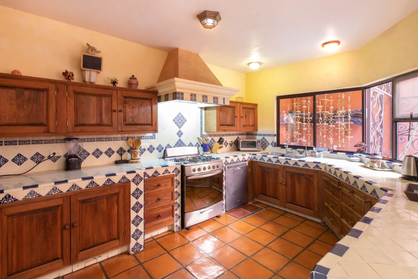 Casa Brillante, kitchen with wood cabinets and Talavera tile counters, San Miguel de Allende
