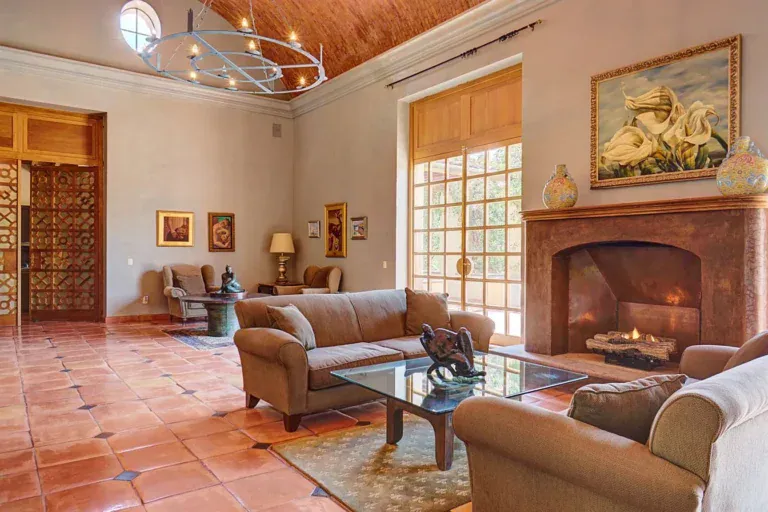 Hacienda Candelaria, great room with a stone fireplace, a vaulted brick ceiling and tile floors, San Miguel de Allende