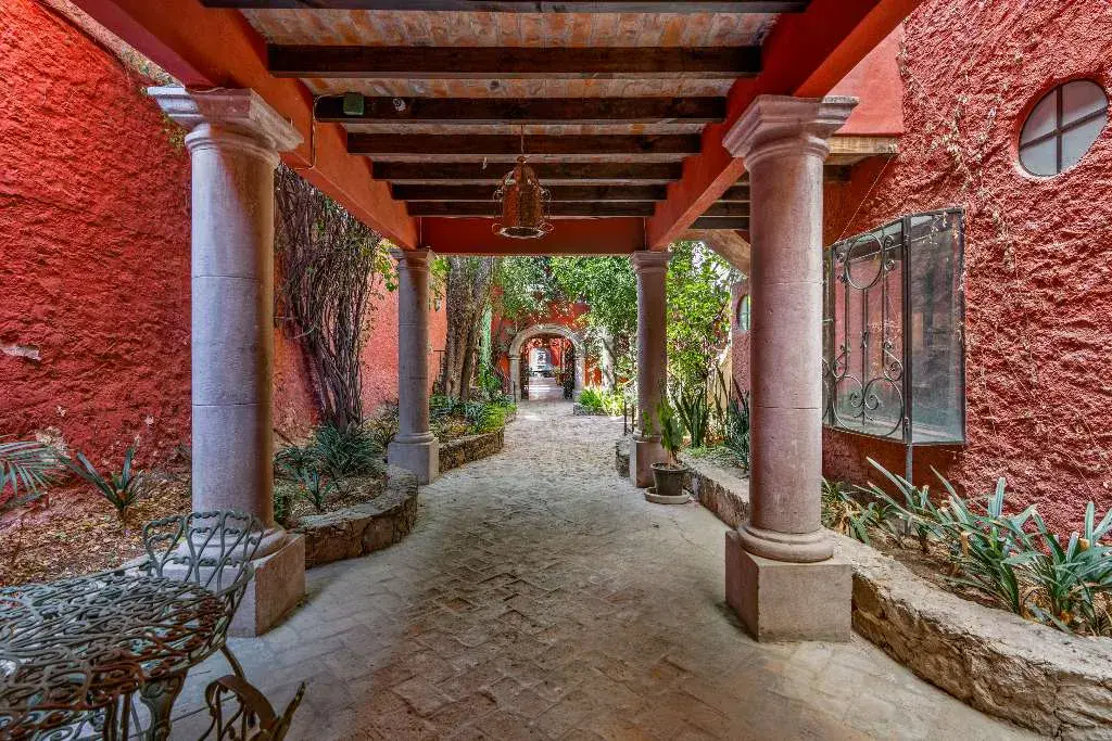 Hotel Casa Luna, stone arcade walkway with red walls and lanterns, San Miguel de Allende