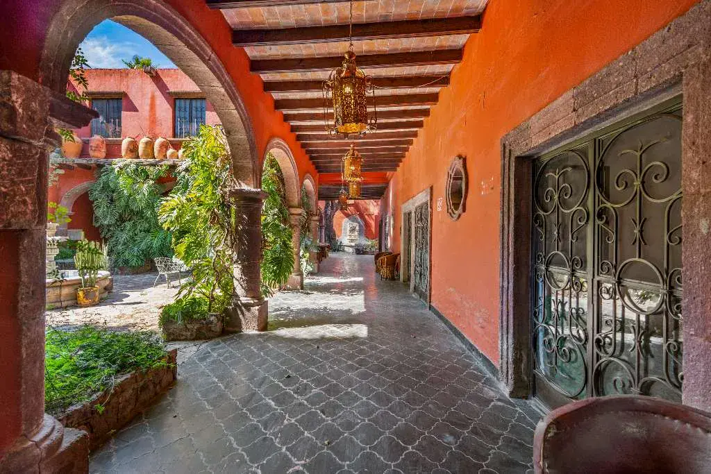Hotel Casa Luna, arcade with wrought-iron doors opening onto the courtyard, San Miguel de Allende
