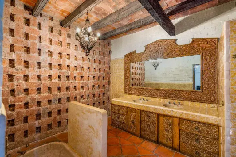 Hotel Casa Luna, bathroom with a brick lattice wall and a carved wood vanity, San Miguel de Allende
