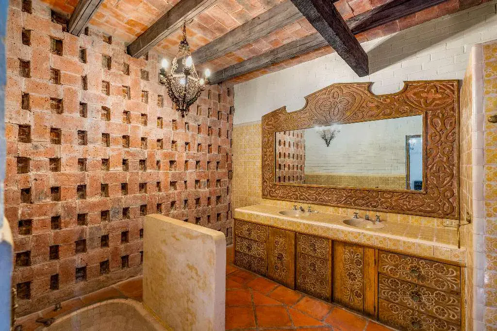 Hotel Casa Luna, bathroom with a brick lattice wall and a carved wood vanity, San Miguel de Allende