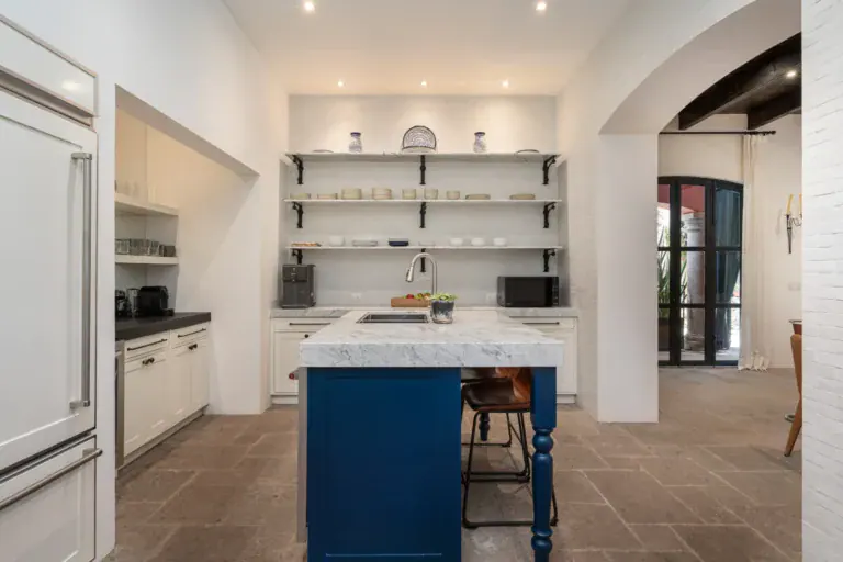 Casa Santa Mónica, kitchen with an arched opening toward the hall, San Miguel de Allende