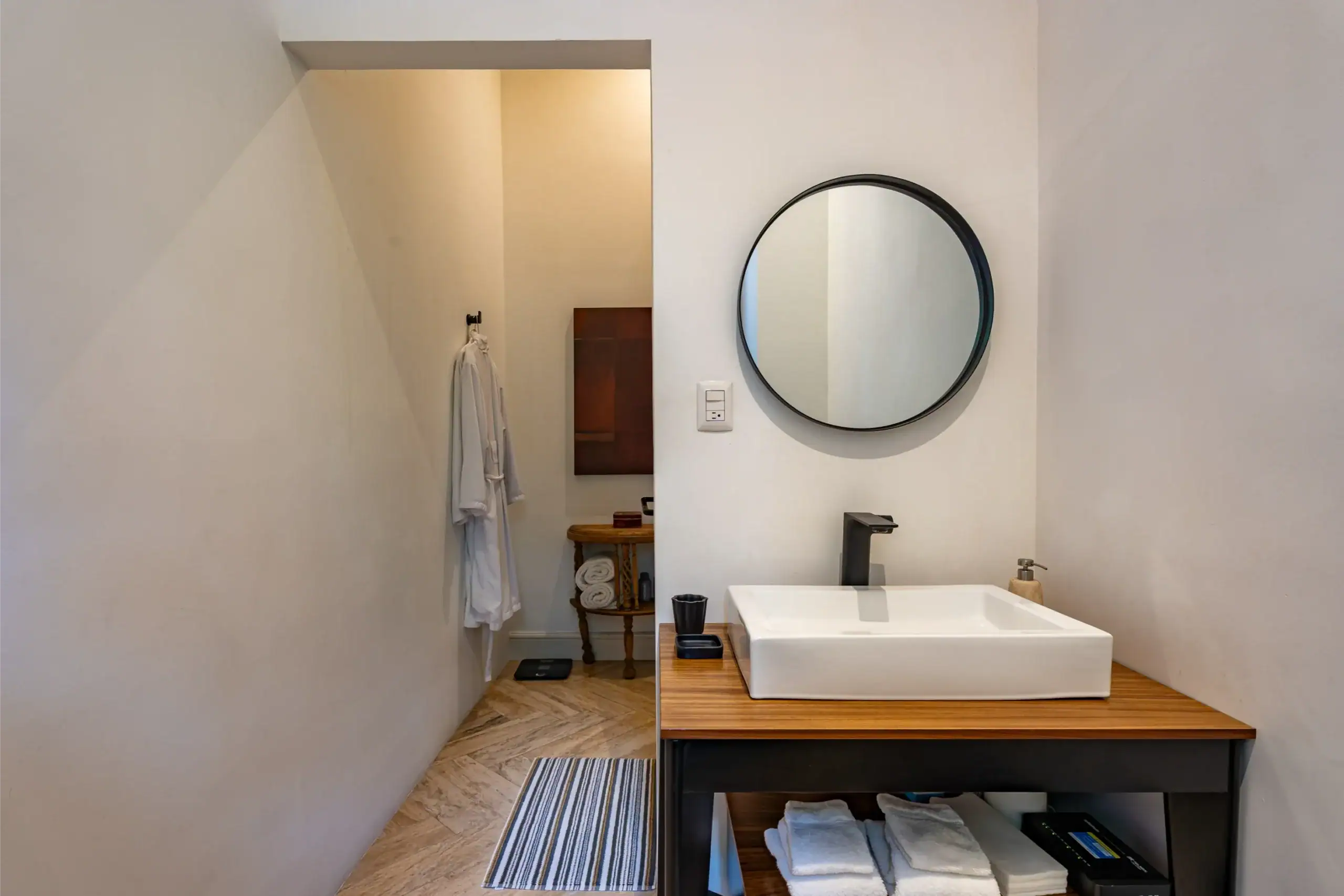 Casa Santa Mónica, ensuite sink area with a round mirror and a vessel sink, San Miguel de Allende