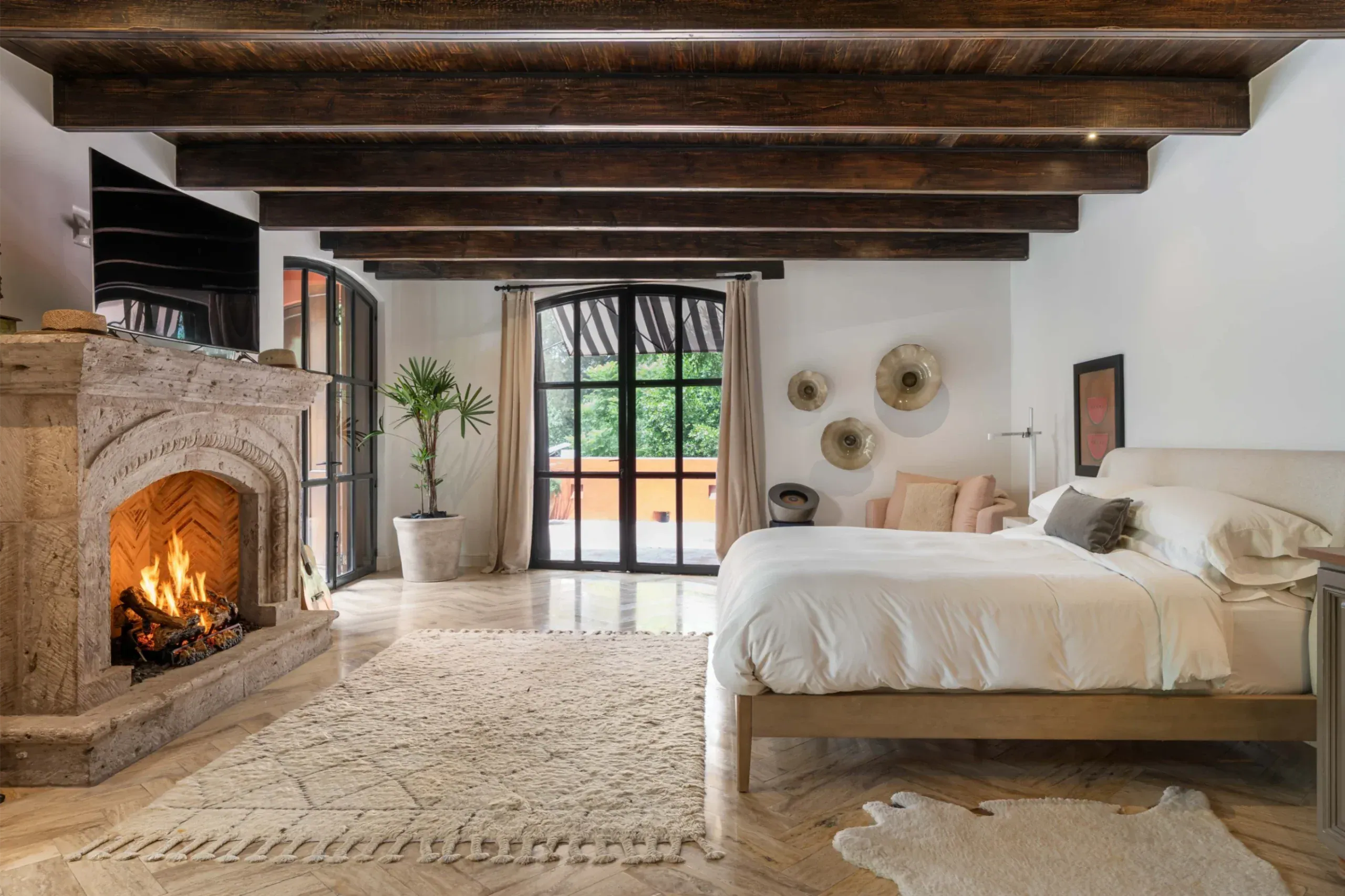 Casa Santa Mónica, primary suite with a fireplace and a view to the terrace, San Miguel de Allende