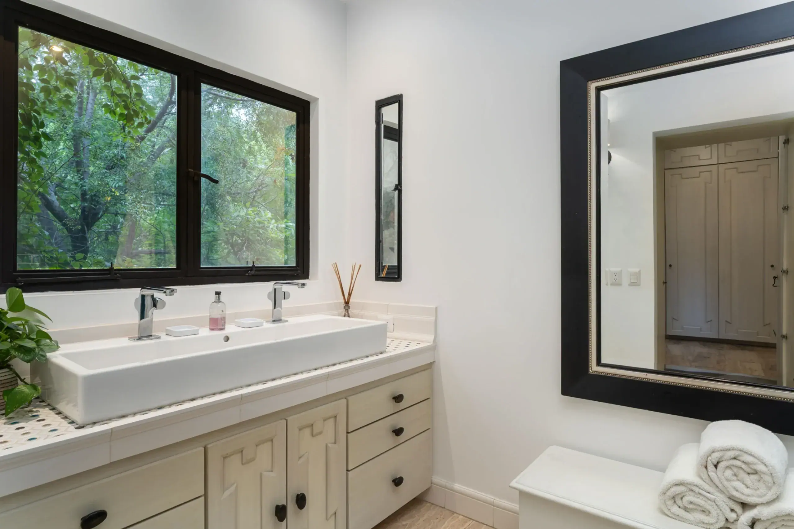 Casa Santa Mónica, bathroom with a double trough sink and a large mirror, San Miguel de Allende