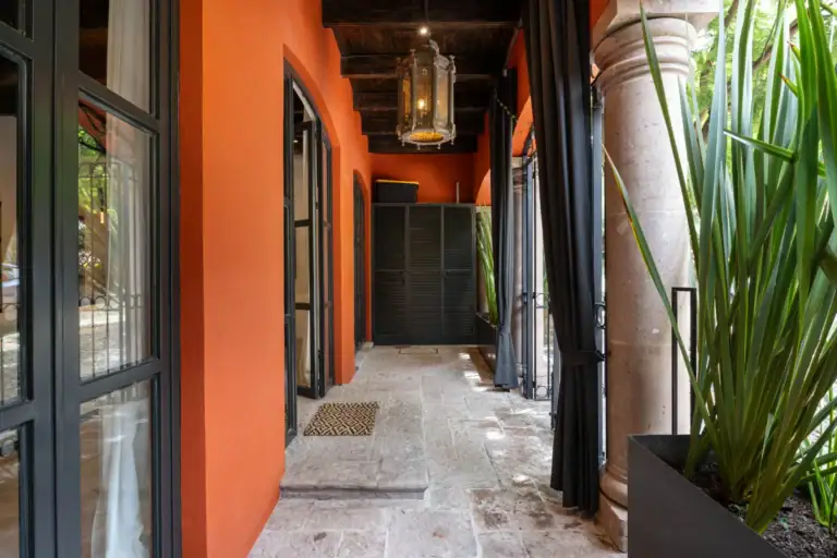 Casa Santa Mónica, covered gallery with steel-framed doors and a lantern, San Miguel de Allende