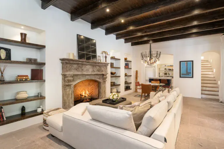 Casa Santa Mónica, stone fireplace with built-in shelves and white sofas, San Miguel de Allende
