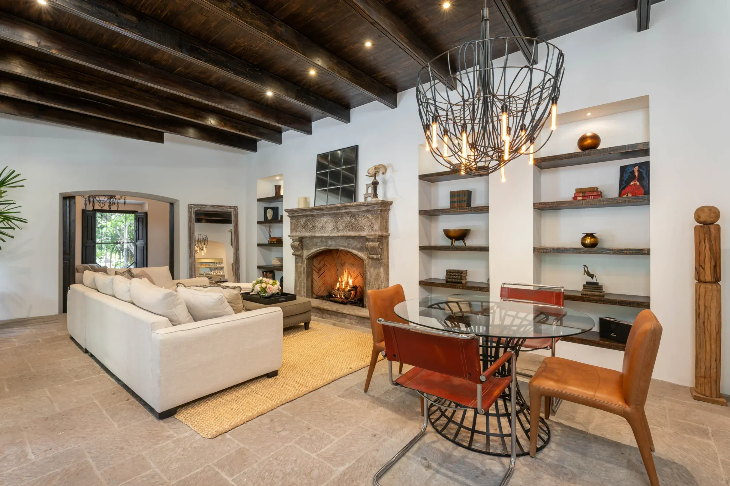 Casa Santa Mónica, living and dining area with a glass dining table and orange leather chairs, San Miguel de Allende