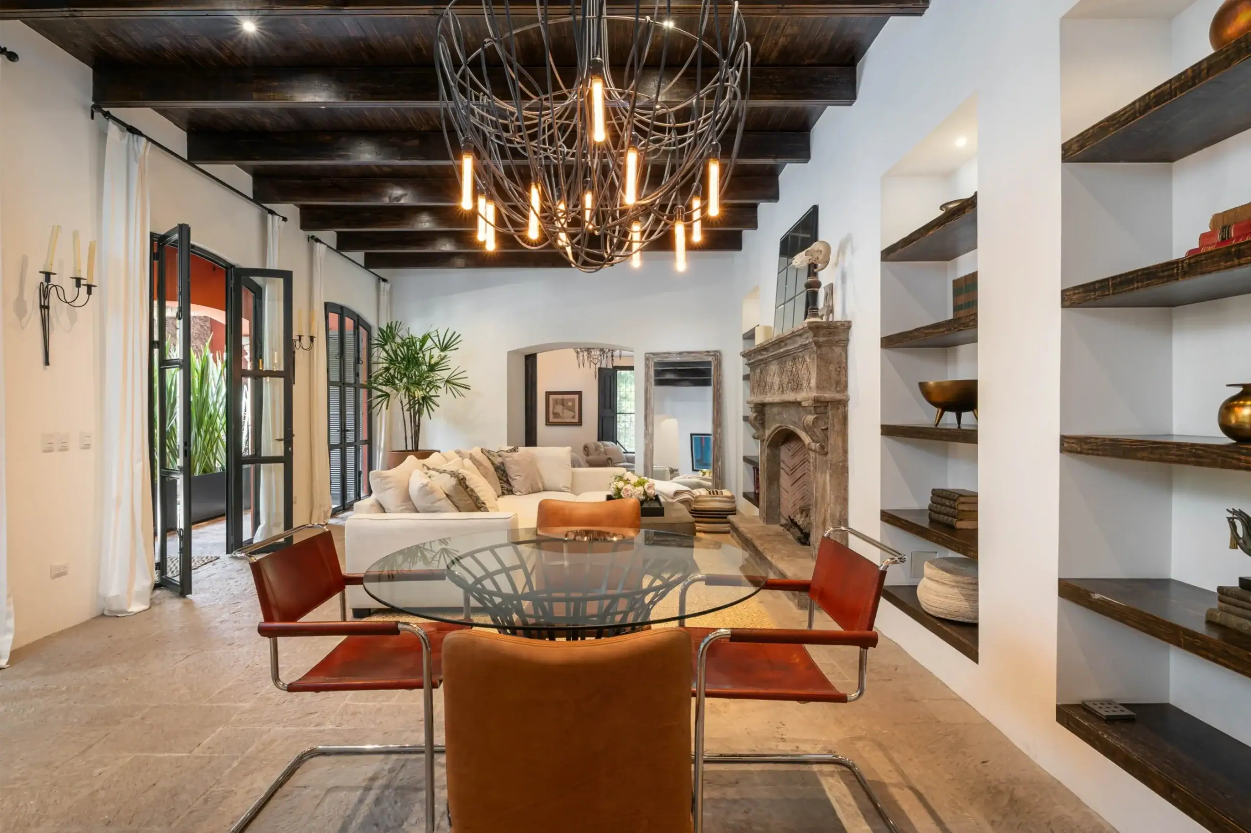 Casa Santa Mónica, dining area with a wrought-iron chandelier and built-in shelves, San Miguel de Allende