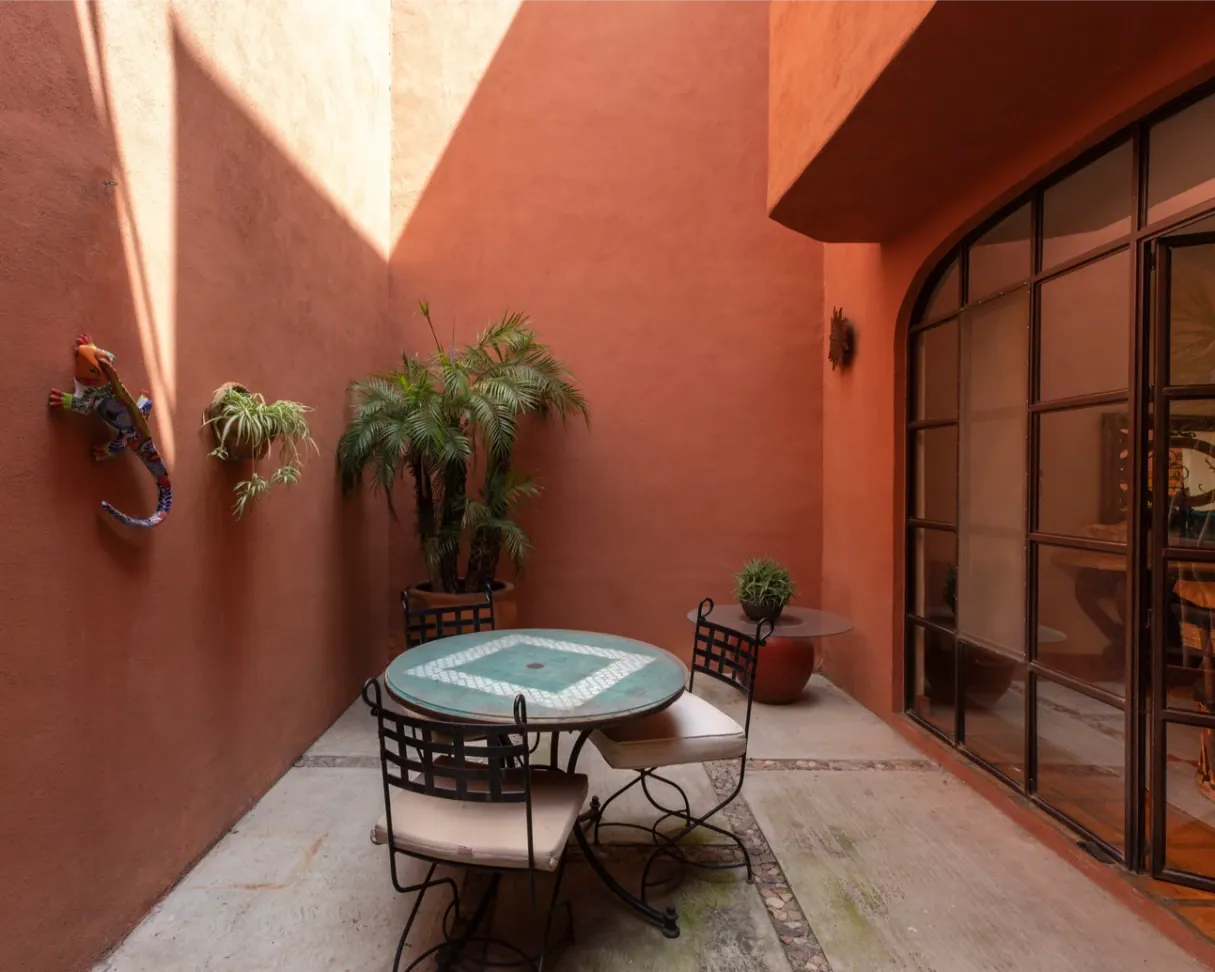 Casa Brillante, terracotta patio with a mosaic table and chairs, San Miguel de Allende