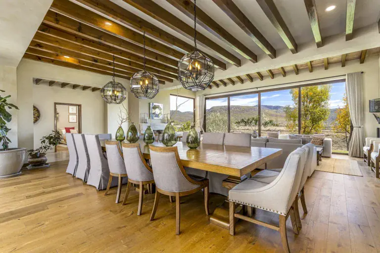 Mañanitas Residence, long dining table and living room under a wood beam ceiling, San Miguel de Allende