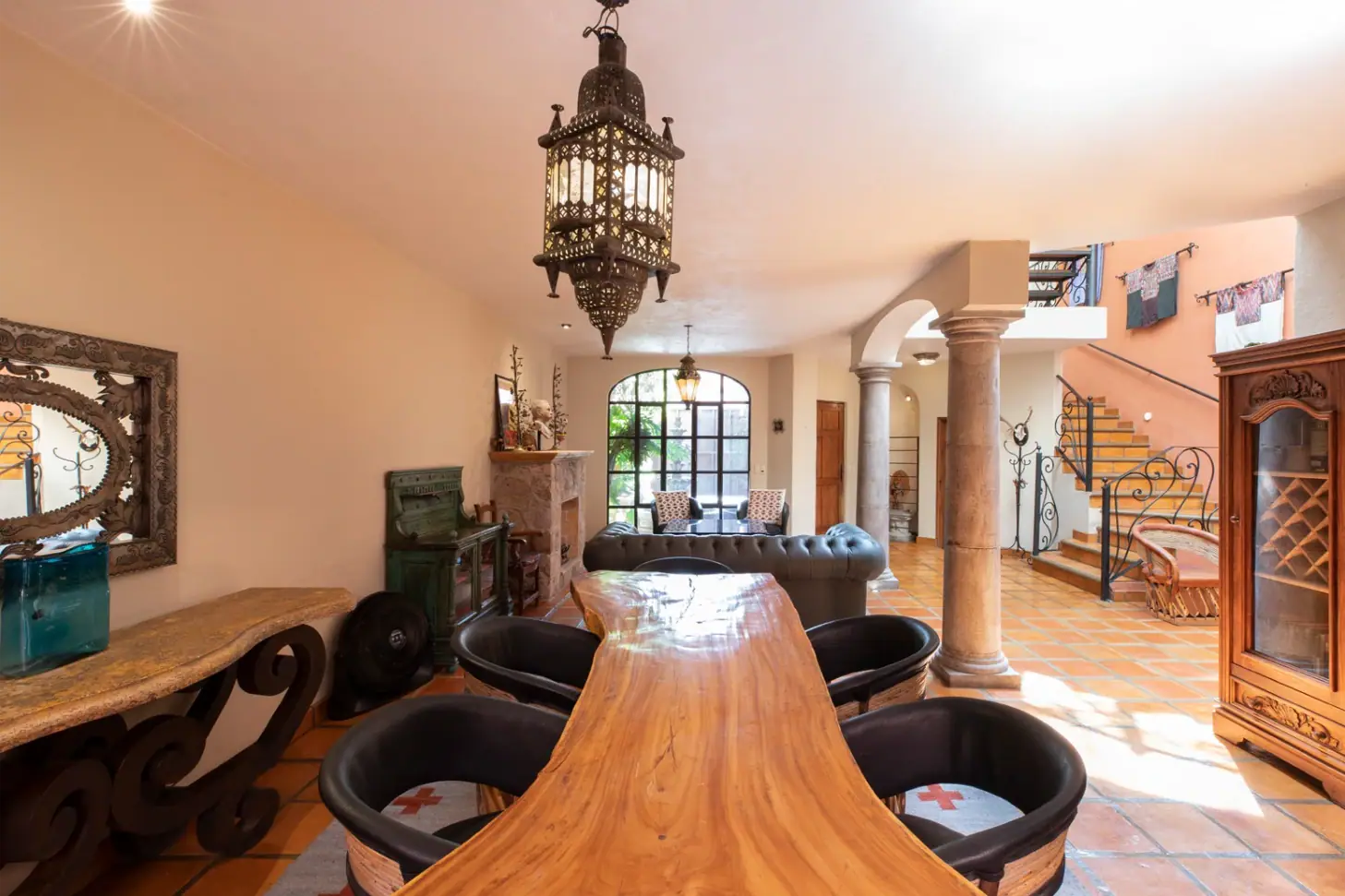 Casa Brillante, living and dining area with a live-edge table and a hanging lantern, San Miguel de Allende