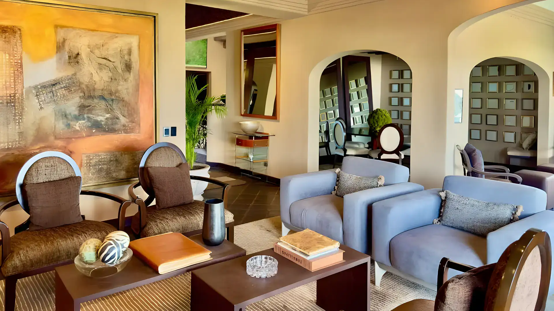 Raíz de las Nubes, living room with blue-gray armchairs, patterned chairs and a large abstract painting, San Miguel de Allende