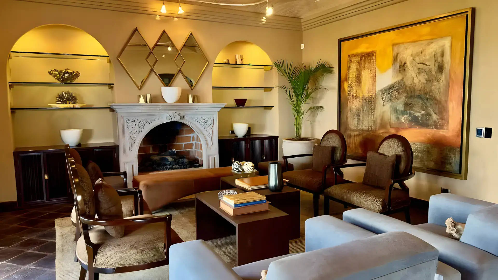 Raíz de las Nubes, living room with an arched stone fireplace, built-in glass shelves and a large painting, San Miguel de Allende