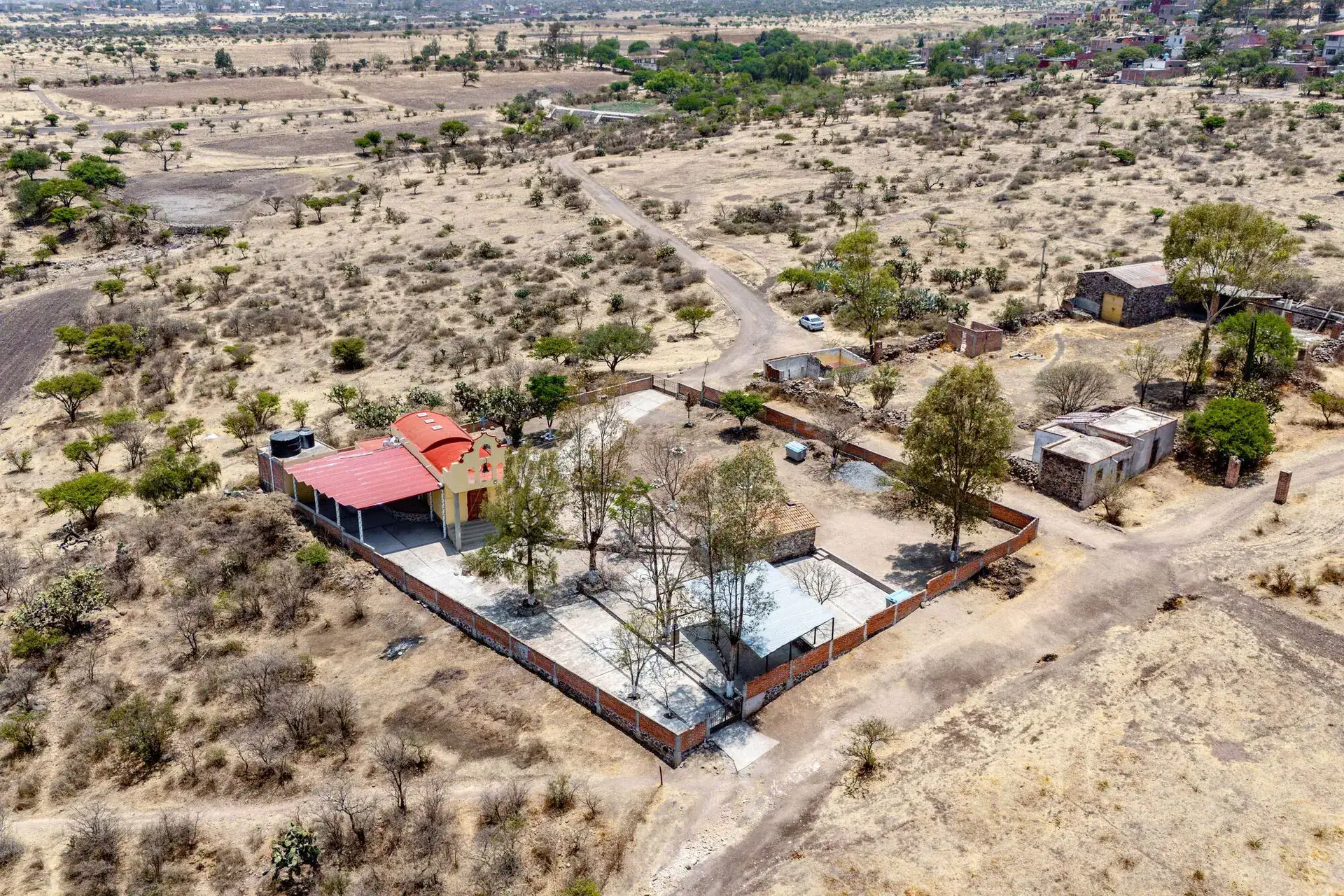 Rancho Guadalupe, aerial view of a walled farm compound with a red-roofed building and outbuildings, San Miguel de Allende