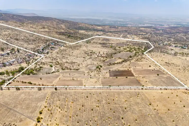 Rancho Guadalupe, aerial view of the white parcel boundary across scrub and plowed fields with a village at the left, San Miguel de Allende