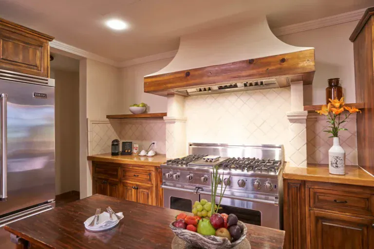 Rosewood Residence 7, kitchen with a professional range, a plaster hood and a wood island, San Miguel de Allende