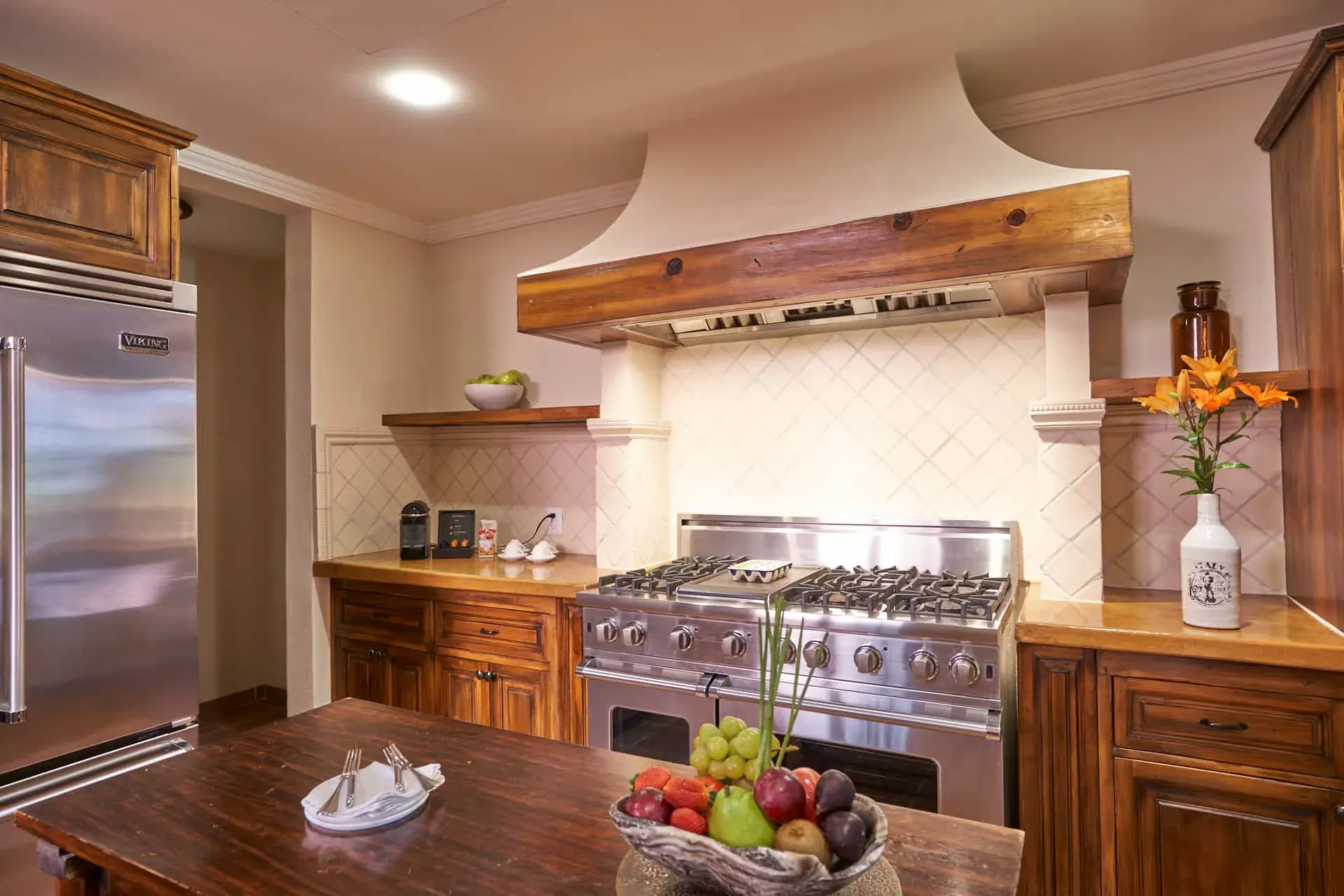 Rosewood Residence 7, kitchen with a professional range, a plaster hood and a wood island, San Miguel de Allende