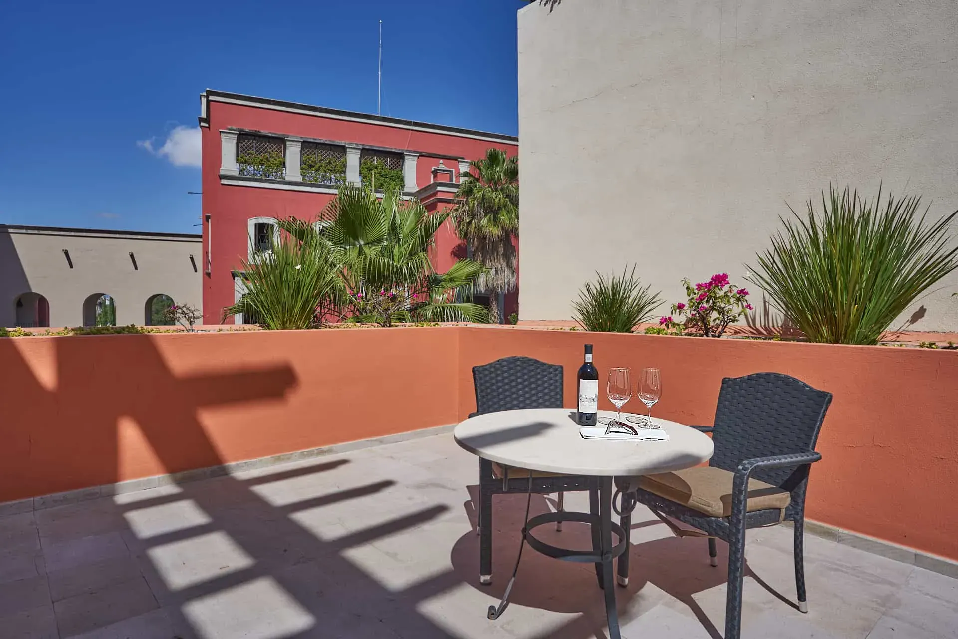 Rosewood Residence 7, terracotta terrace with a bistro table and a view of the neighboring buildings, San Miguel de Allende