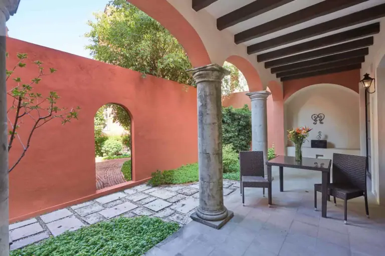 Rosewood Residence 7, covered garden patio with a stone column and a seating area, San Miguel de Allende