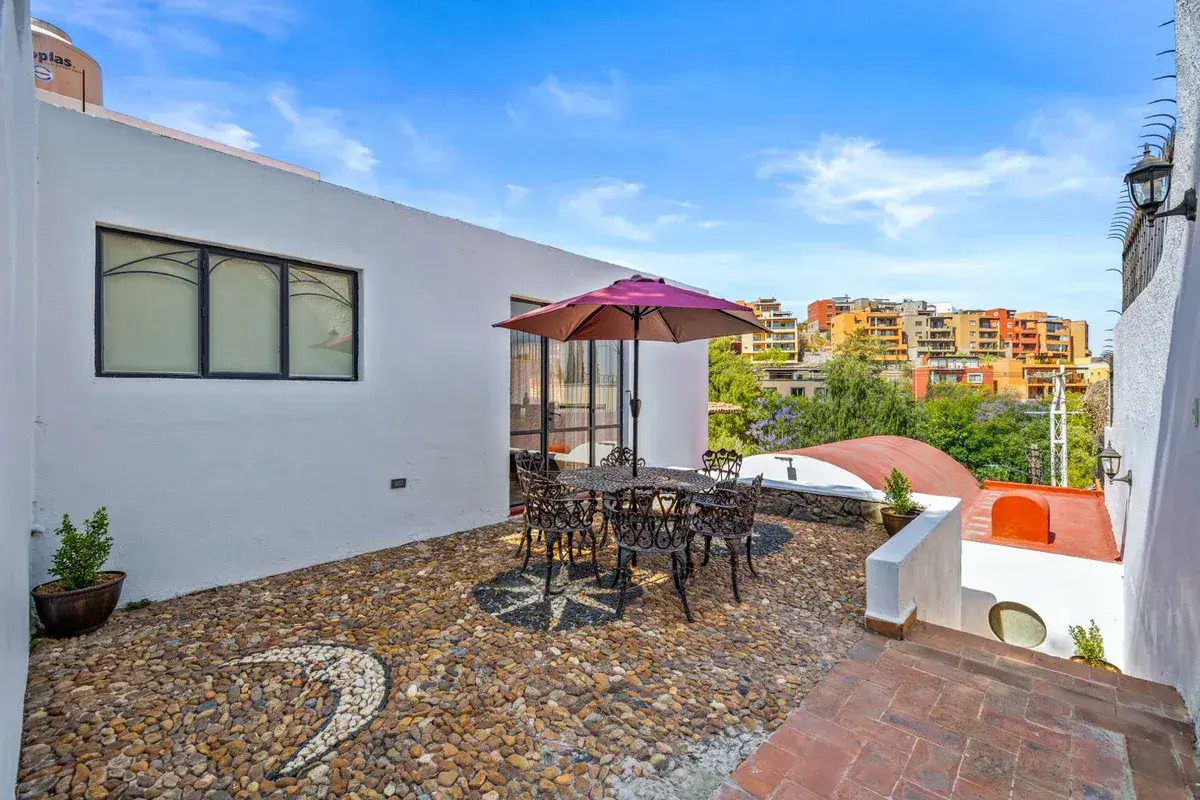 Santo Domingo House, rooftop terrace with an umbrella table, a pebble mosaic and a view over the neighborhood, San Miguel de Allende