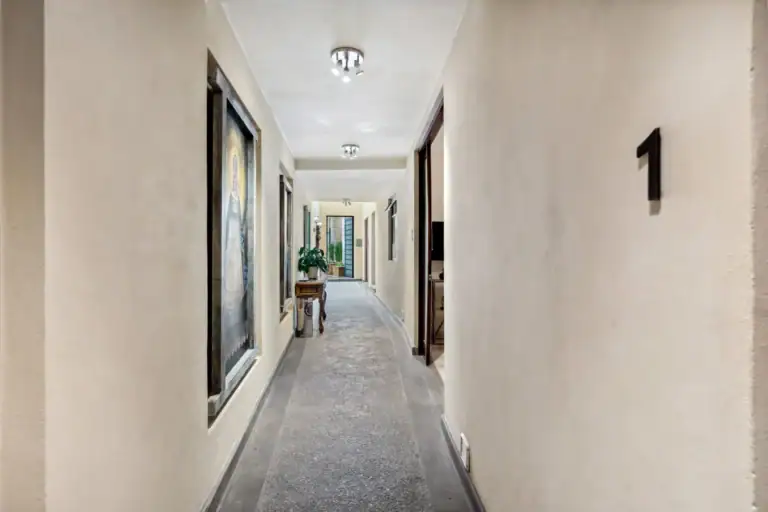 Suites Casa Vistas, long hallway of the suites with a framed painting and the number 1 on the wall, San Miguel de Allende