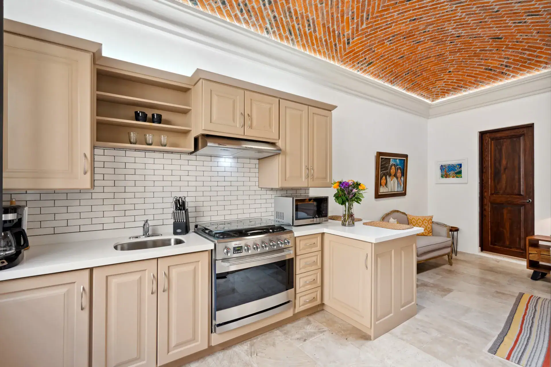 Suites Casa Vistas, suite kitchen with beige cabinets, subway tile backsplash and a brick vaulted ceiling, San Miguel de Allende