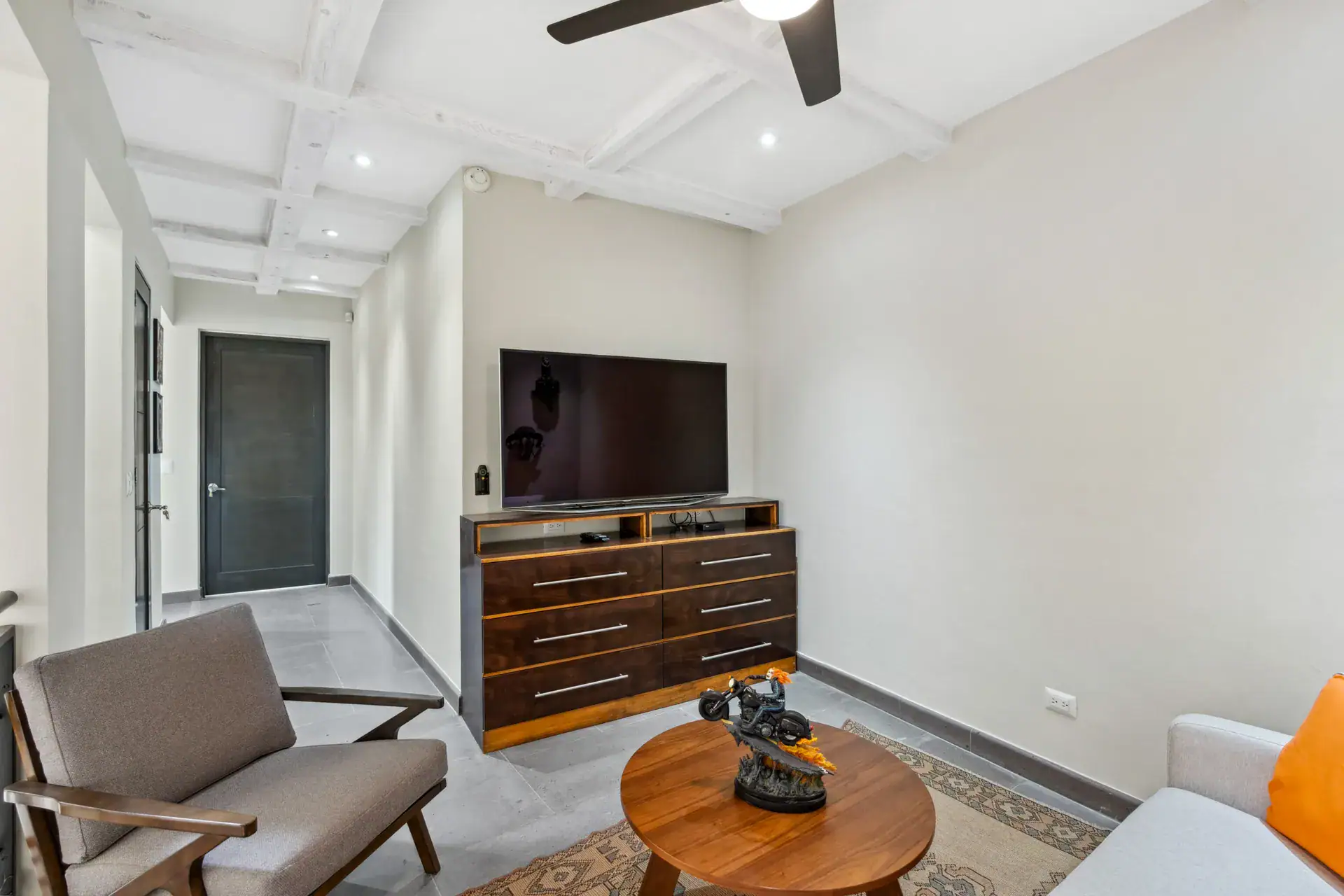 Suites Casa Vistas, upstairs media room with a television on a wood dresser and a chair, San Miguel de Allende