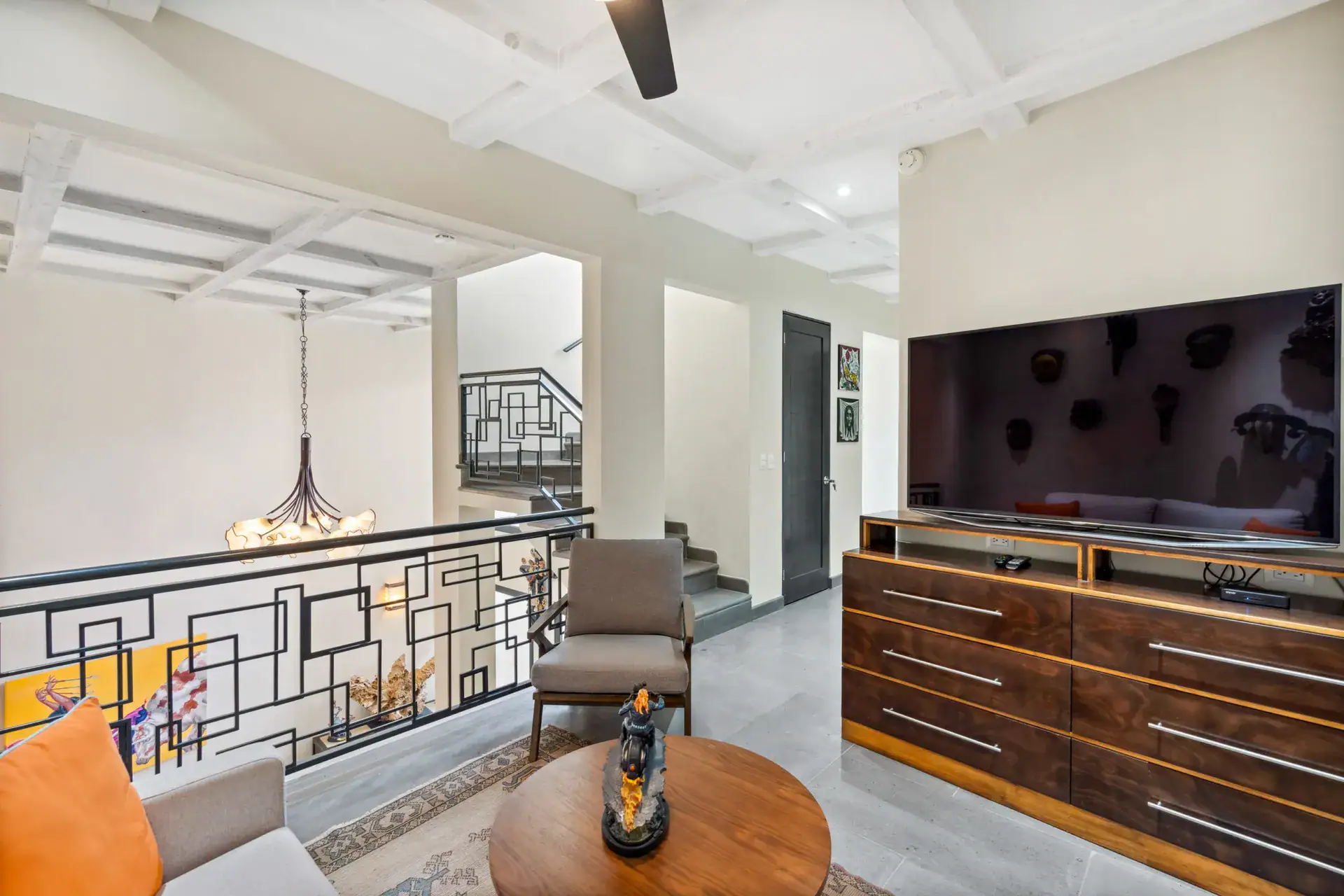 Suites Casa Vistas, mezzanine landing with an iron railing, television and a round table, San Miguel de Allende