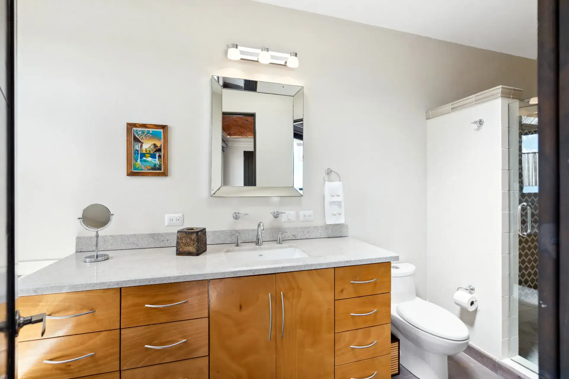 Suites Casa Vistas, bathroom with a granite vanity, wood cabinets and a shower, San Miguel de Allende