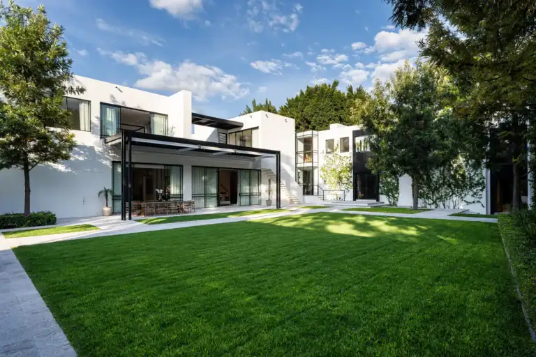 Villa del Parque Central, white two-story villa and manicured lawn under a blue sky, San Miguel de Allende