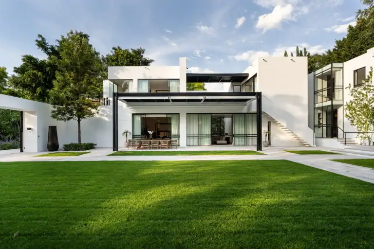 Villa del Parque Central, contemporary villa with covered dining terrace, exterior staircase and green lawn, San Miguel de Allende