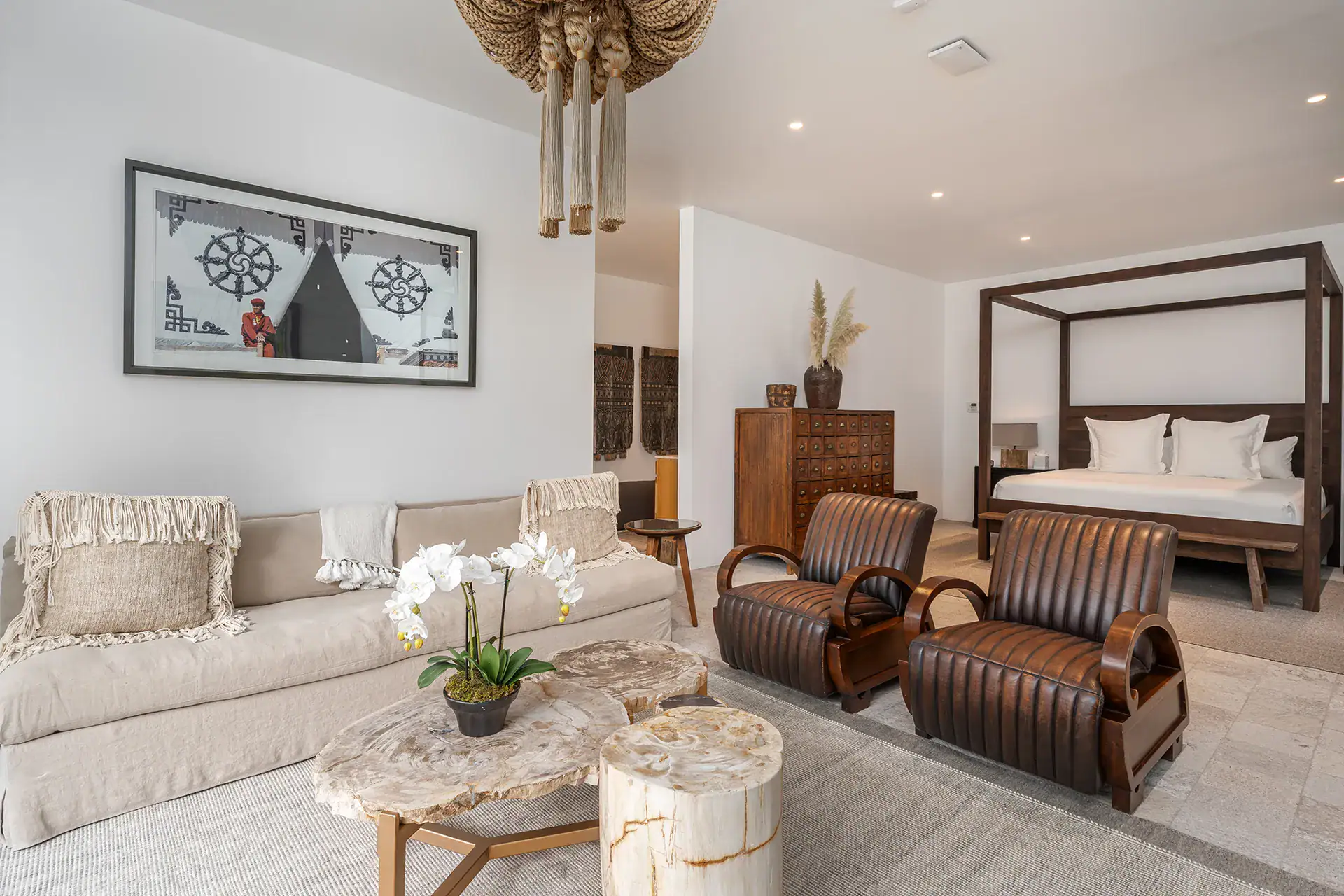Villa del Parque Central, bedroom and sitting area with a four-poster bed, leather club chairs and a petrified-wood coffee table, San Miguel de Allende