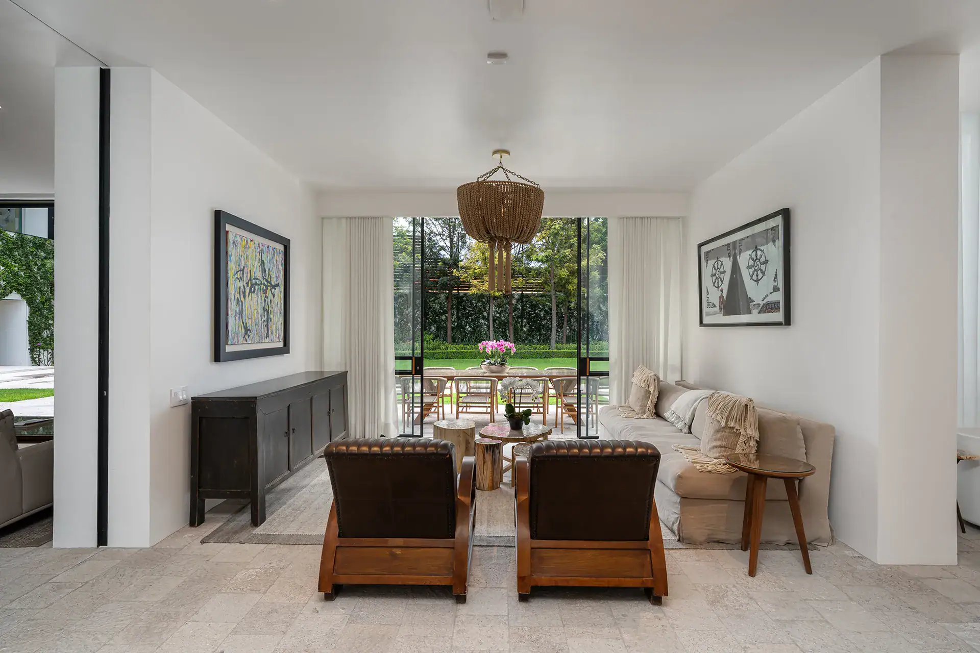 Villa del Parque Central, sitting room with leather armchairs and sofa facing the garden through large glass doors, San Miguel de Allende