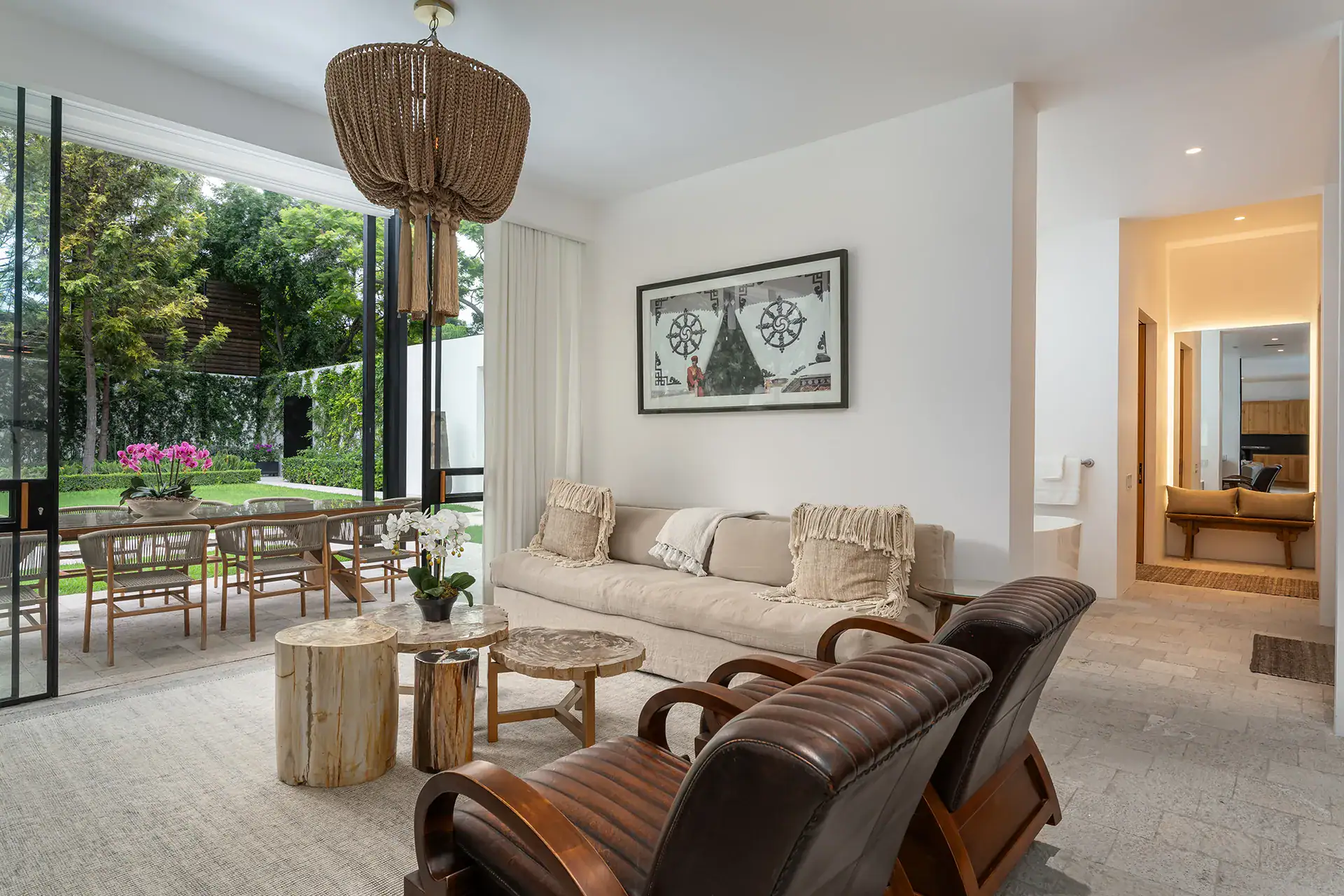 Villa del Parque Central, living area with sofa, leather armchairs and a woven pendant light beside an en suite bathroom, San Miguel de Allende