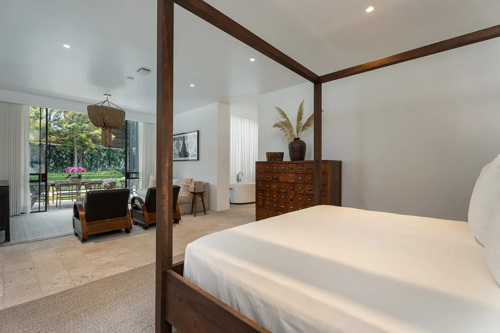 Villa del Parque Central, four-poster bed with views through the glass wall to the garden, San Miguel de Allende
