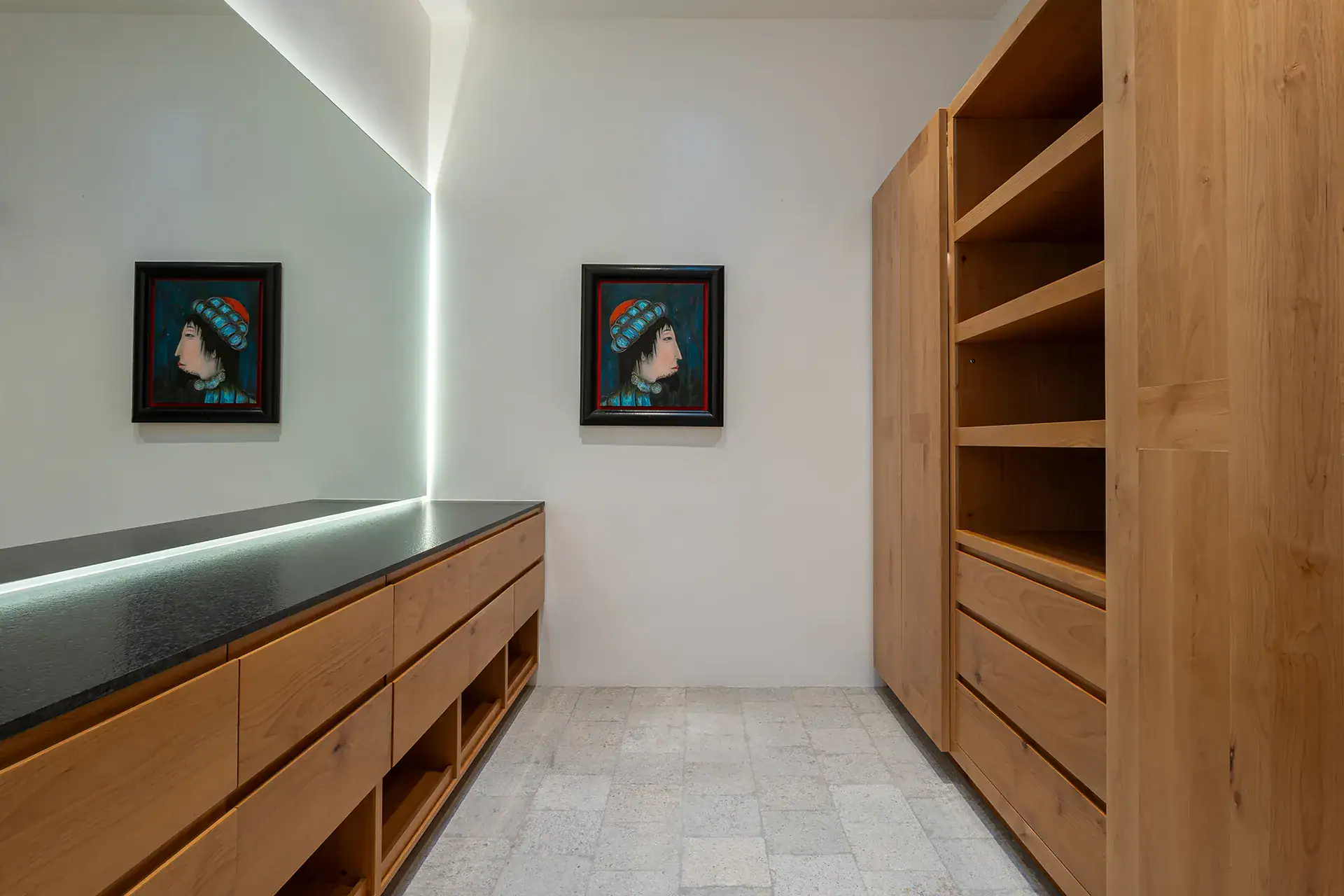 Villa del Parque Central, oak cabinetry and shelving with framed portraits and a glowing light strip, San Miguel de Allende