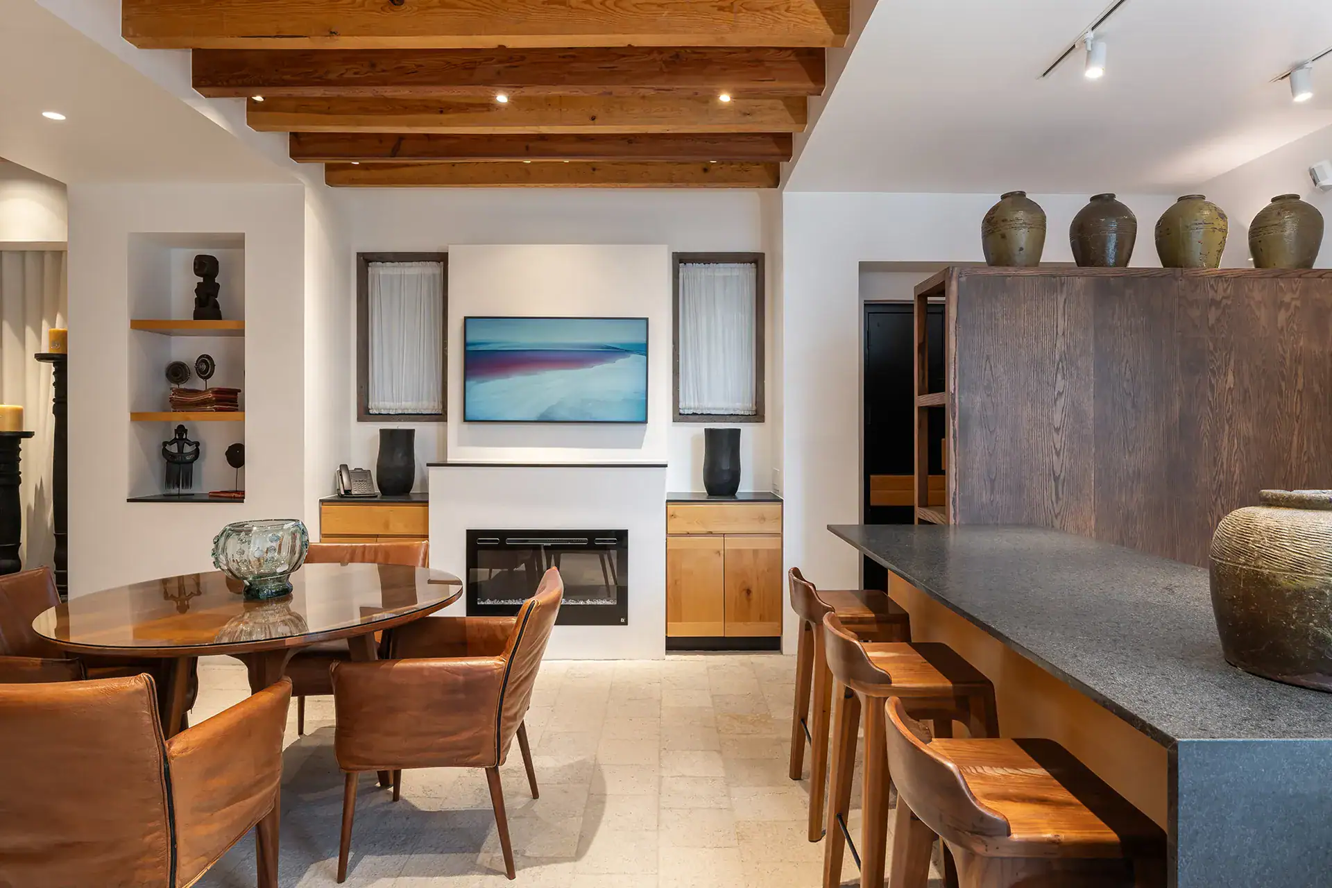 Villa del Parque Central, beamed-ceiling dining area with leather chairs, fireplace and open kitchen, San Miguel de Allende