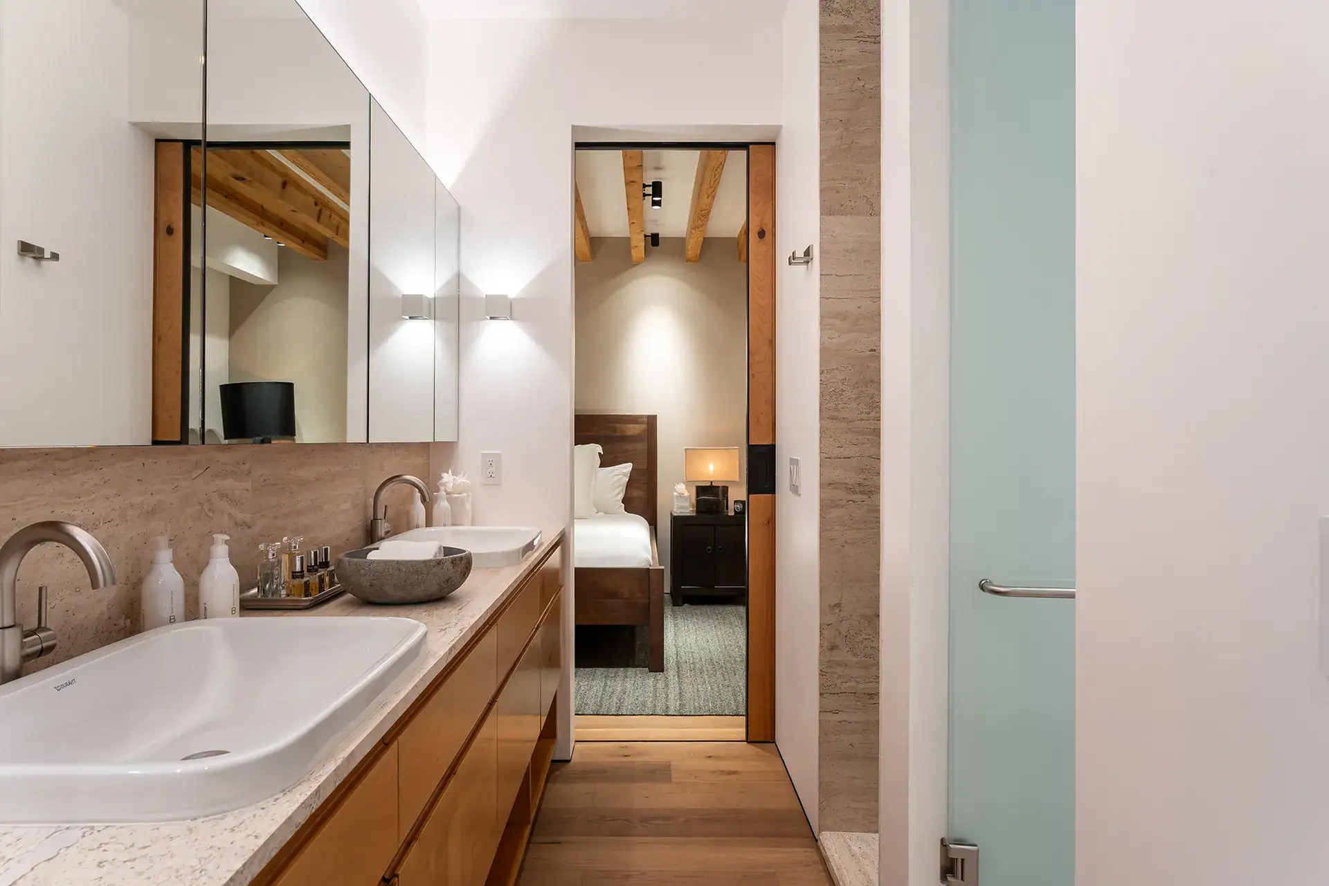 Villa del Parque Central, bathroom with a vessel sink and oak vanity and a view into a bedroom, San Miguel de Allende